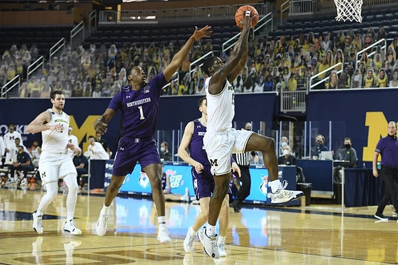Hunter Dickinson (1) and Chaundee Brown Jr. (15)