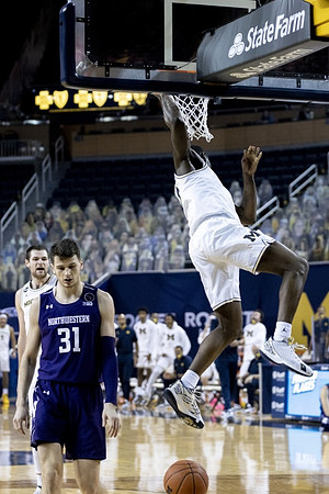 Hunter Dickinson (1) and Chaundee Brown Jr. (15)