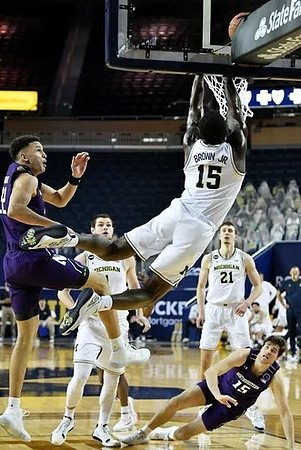 Hunter Dickinson (1), Chaundee Brown Jr. (15), and Franz Wagner (21)