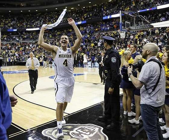 Mitch McGary (4) and John Beilein