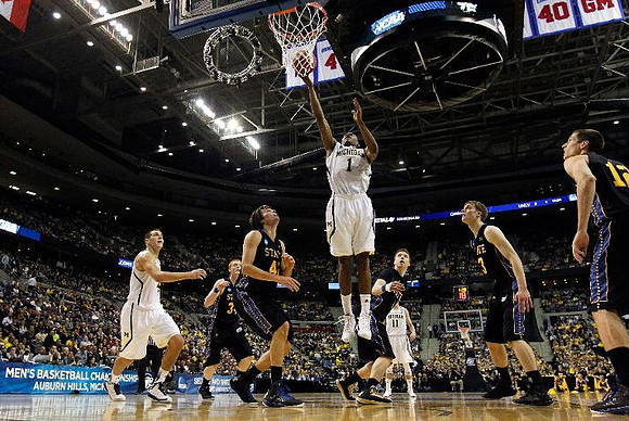 Mitch McGary (4), Glenn Robinson III (1), and Nik Stauskas (11)