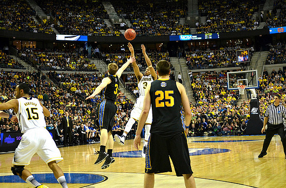 Jon Horford (15) and Trey Burke (3)