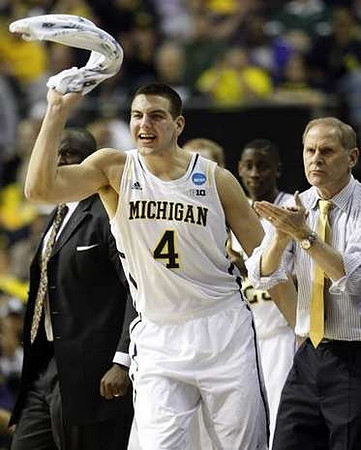 Bacari Alexander, Mitch McGary (4), Caris LeVert (23), and John Beilein