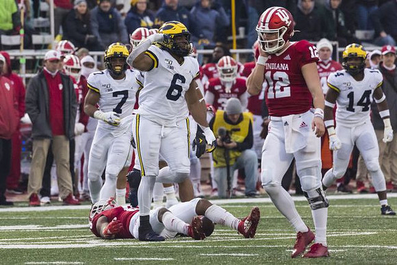 Khaleke Hudson (7), Josh Uche (6), and Josh Metellus (14)