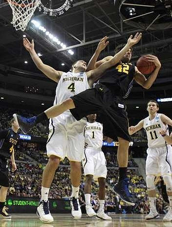 Mitch McGary (4), Glenn Robinson III (1), and Nik Stauskas (11)