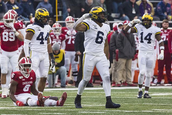 Cameron McGrone (44), Josh Uche (6), and Josh Metellus (14)
