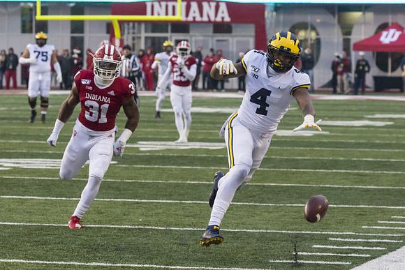 Jon Runyan Jr. (75) and Nico Collins (4)
