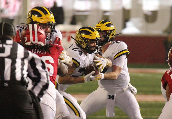 Jalen Mayfield (73), Shea Patterson (2), and Zach Charbonnet (24)