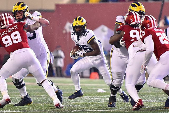 Jalen Mayfield (73) and Hassan Haskins (25)