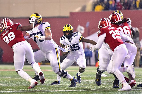 Jalen Mayfield (73) and Hassan Haskins (25)