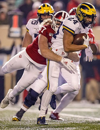 Jon Runyan Jr. (75) and Zach Charbonnet (24)