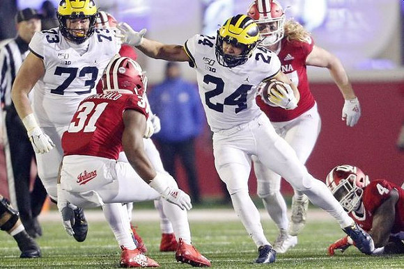 Jalen Mayfield (73) and Zach Charbonnet (24)