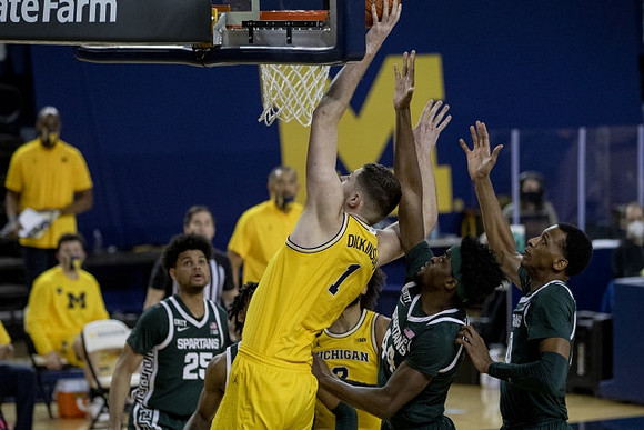 Hunter Dickinson (1) and Isaiah Livers (2)
