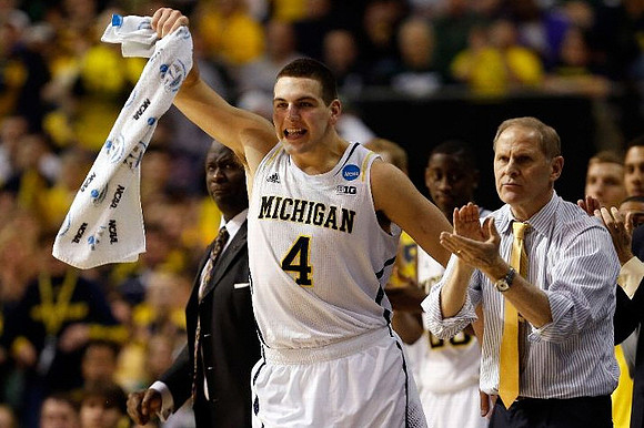 Bacari Alexander, Mitch McGary (4), Caris LeVert (23), and John Beilein