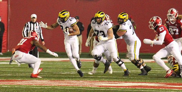 Zach Charbonnet (24), Jalen Mayfield (73), and Ben Bredeson (74)