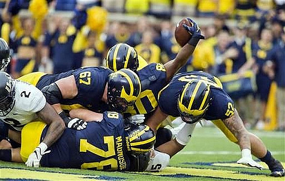 Kyle Kalis (67), Erik Magnuson (78), Khalid Hill (80), and Mason Cole (52)