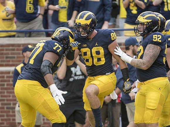 Grant Newsome (77), Jake Butt (88), and Mason Cole (52)