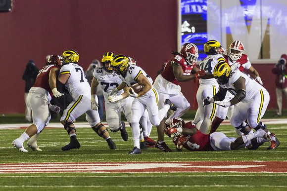 Ben Bredeson (74), Jalen Mayfield (73), Zach Charbonnet (24), Sean McKeon (84), and Michael Onwenu (50)