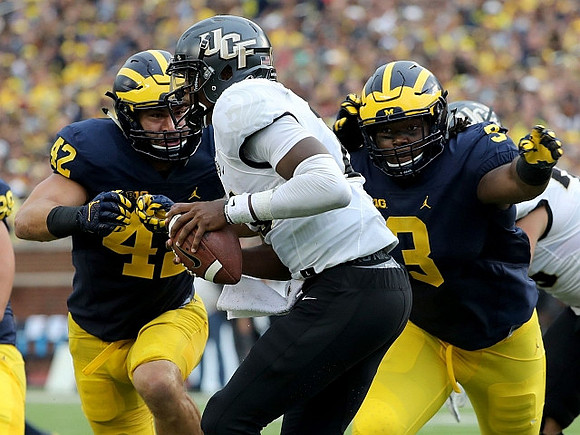 Ben Gedeon (42) and Rashan Gary (3)