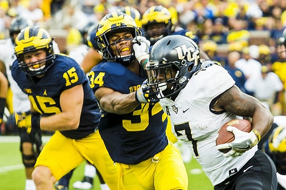 Chase Winovich (15) and Jeremy Clark (34)