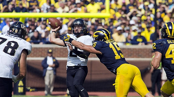 Chase Winovich (15) and Ben Gedeon (42)