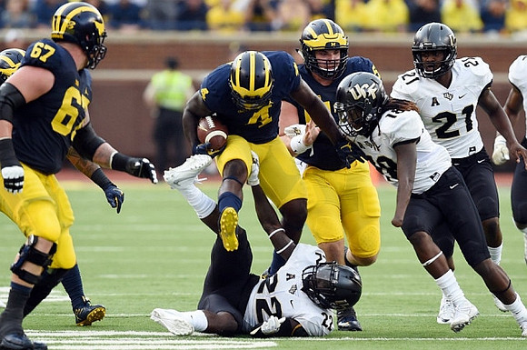 Kyle Kalis (67) and De'Veon Smith (4)