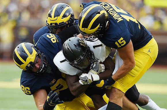 Ryan Glasgow (96) and Chase Winovich (15)