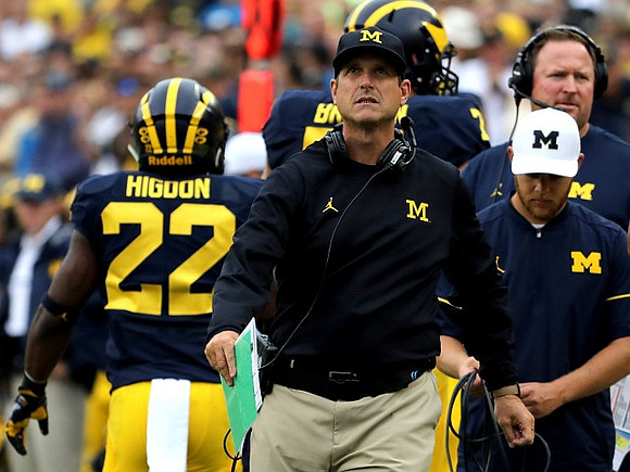 Jim Harbaugh, Karan Higdon (22), and Tim Drevno