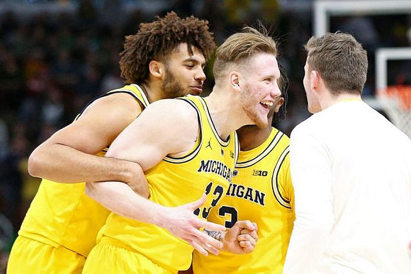 Isaiah Livers (4), Ignas Brazdeikis (13), and Zavier Simpson (3)