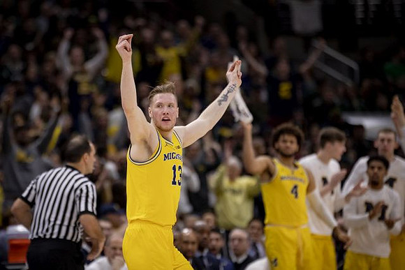 Ignas Brazdeikis (13) and Michigan Team