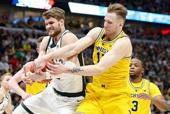 Jon Teske (15), Ignas Brazdeikis (13), and Zavier Simpson (3)