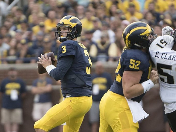 Wilton Speight (3) and Mason Cole (52)