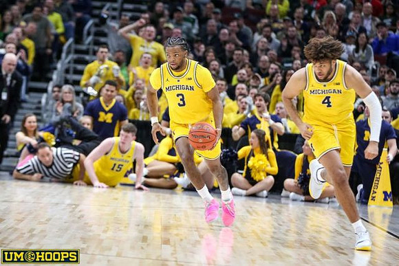 Jon Teske (15), Zavier Simpson (3), and Isaiah Livers (4)