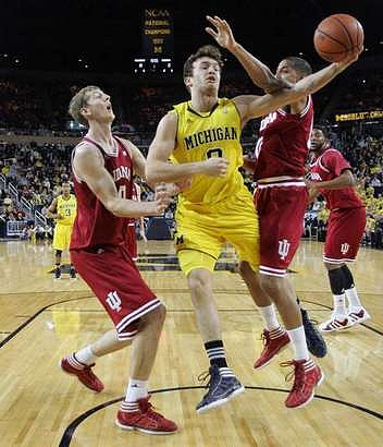 Zack Novak (0) and Trey Burke (3)
