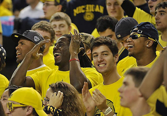 J.B. Fitzgerald, Denard Robinson, and Roy Roundtree