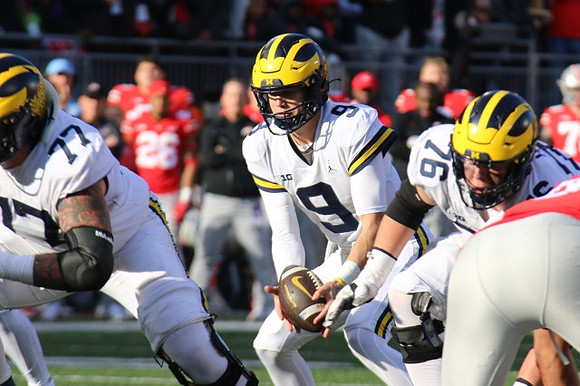 Trevor Keegan (77), J.J. McCarthy (9), and Ryan Hayes (76)