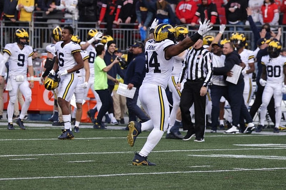 J.J. McCarthy (9), Cornelius Johnson (6), Kris Jenkins (94), and Michigan Team