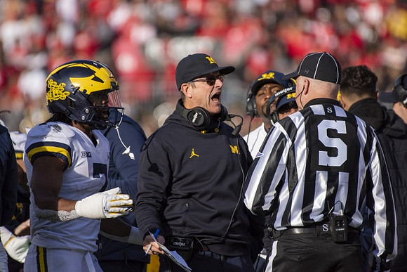Donovan Edwards (7) and Jim Harbaugh
