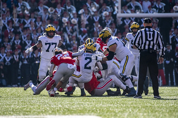 Trevor Keegan (77), Olusegun Oluwatimi (55), Blake Corum (2), Ryan Hayes (76), and J.J. McCarthy (9)