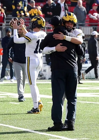 Davis Warren (16), J.J. McCarthy (9), and Jim Harbaugh