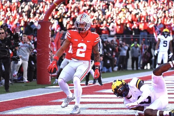 Mike Sainristil (0) and DJ Turner (5)