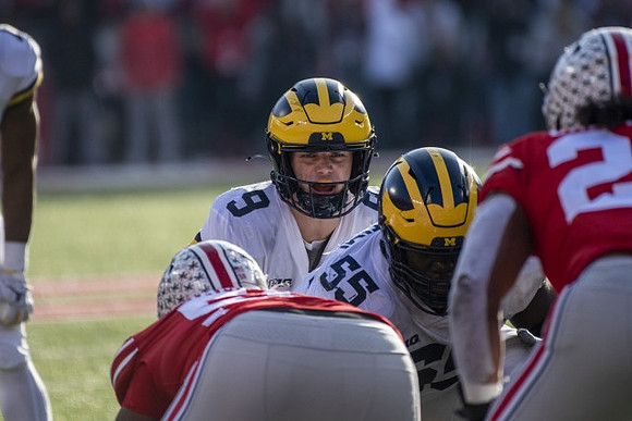 J.J. McCarthy (9) and Olusegun Oluwatimi (55)