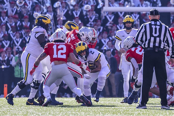 Olusegun Oluwatimi (55), Blake Corum (2), and J.J. McCarthy (9)