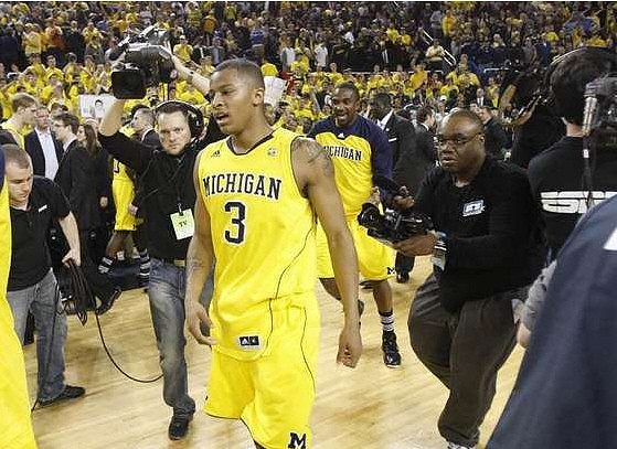 Trey Burke (3) and Corey Person (32)