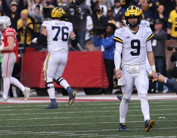 Ryan Hayes (76) and J.J. McCarthy (9)