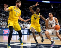 Hunter Dickinson (1) and Moussa Diabate (14)