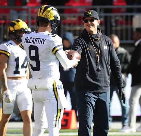 Roman Wilson (14), J.J. McCarthy (9), and Jim Harbaugh