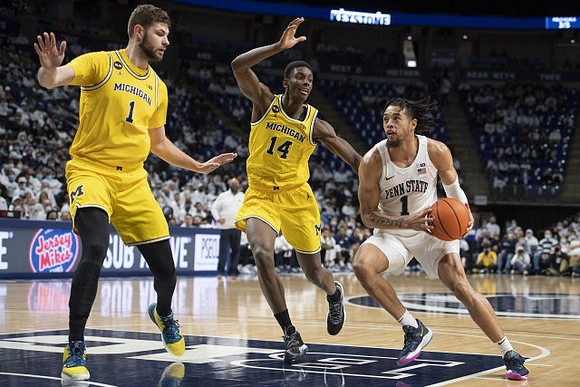 Hunter Dickinson (1) and Moussa Diabate (14)