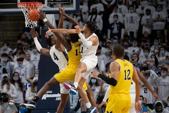 Moussa Diabate (14) and DeVante' Jones (12)