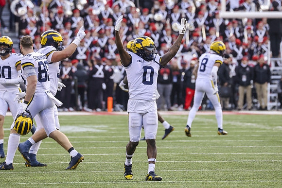 Luke Schoonmaker (86), Mike Sainristil (0), and Ronnie Bell (8)